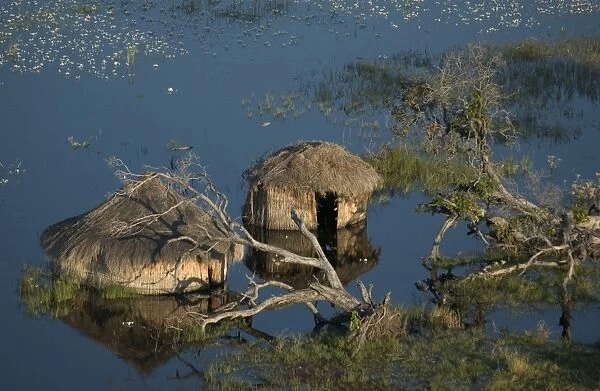 Flooded  /  Huts - Areial view of flooded huts Okavango delta, Botswana, Africa
