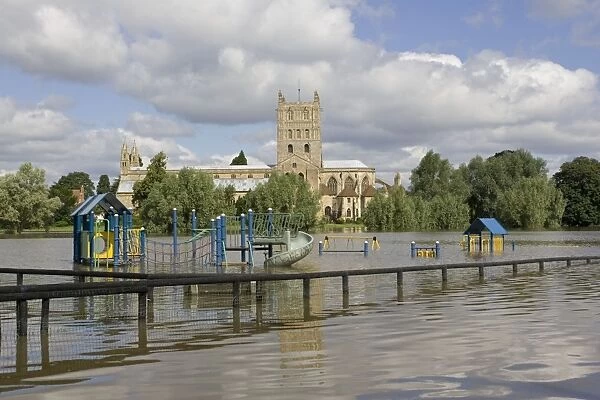 Flooding - childrens playground underwater with Tewkesbury Abbey in background. Unprecedented flooding of the Rivers Severn and Avon July 2007 Gloucestershire UK