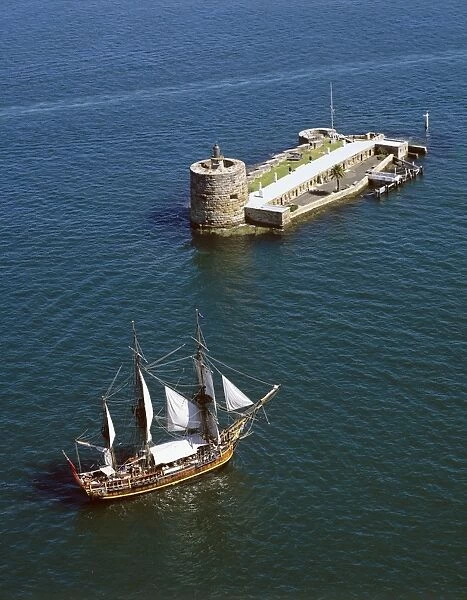 Fort Denison (Pinchgut) aerial, with the ‘Bounty replica sailing nearby, Sydney Harbour National Park, Sydney, New South Wales, Australia JPF46921