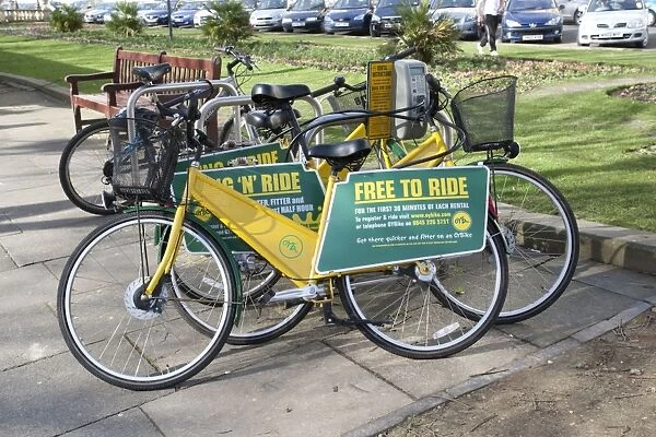 Free to Ride OYB yellow bike rental docking station - Cheltenham Promenade Gloucestershire UK