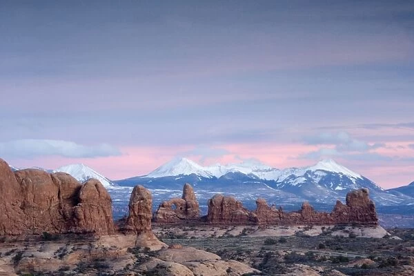 General view across 'The Windows' area towards La Sal mountains, in winter. Arches National Park, Utah. Evening light