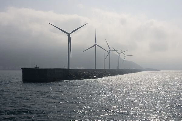 Giant wind turbines on breakwater at entyrance to Bilbao harbour Spain