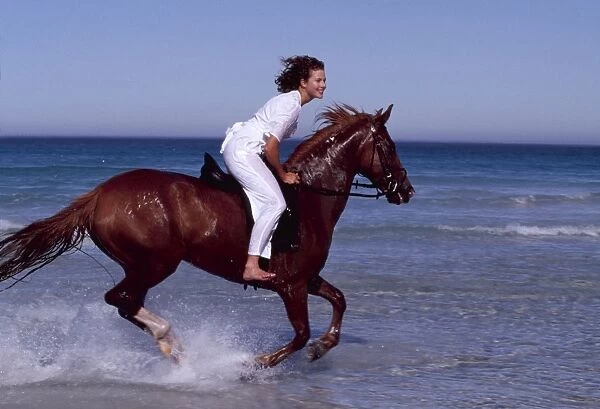 Girl rides HORSE - galloping along sea edge