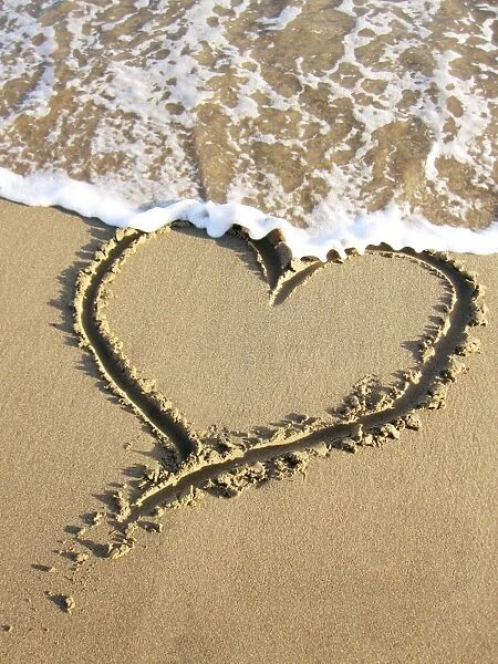Heart drawn in the sand of a beach