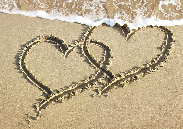 Heart drawn in the sand of a beach Digital Manipulation: added hearts together & sea