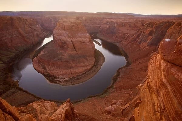Horseshoe Bend - dramatic view of a nearly 360 degree bend of the Colorado river cut into the colorado plateau. At sunset - Horseshoe Bend, Arizona, USA