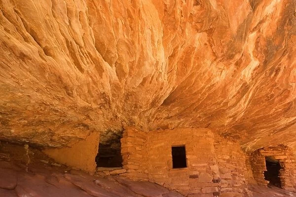 House on Fire Ruin - ancient puebluan dwelling built into an alcove in Mule Canyon. There is an intricate pattern visible on the ceiling of the alcove which, in reflected light, look like flames, giving the ruin its name - Mule Canyon, Cedar Mesa