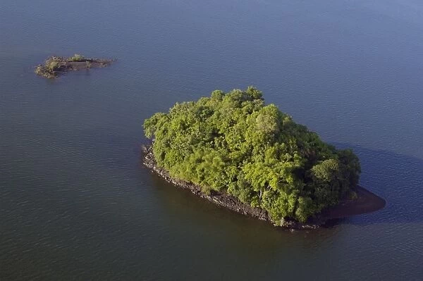 An island covered with rainforest vegetation in Sulu Sea near Sandakan; helicopter view; Sabah, Borneo, Malaysia; morning in June. Ma39. 3091