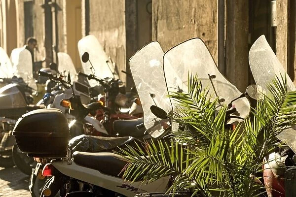 Italy - Rome - street scene with parked mopeds in sunlight
