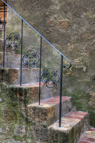 Italy, Tuscany, Pienza. Steps with wrought iron railing leading to the entrance to a home in Pienza. Date: 17-09-2010