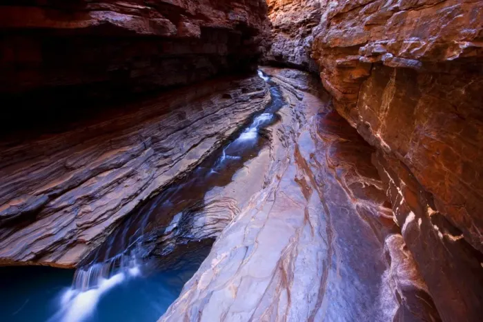 Framed Print : Kermit's Pool - a stream is flowing down Hancock Gorge, surrounded by steep, red and very terraced ciffs, into Kermit's Pool. Because of it's depth the pool's water appears an amazing deep blue Framed Print : Kermit's Pool - a stream is flowing down Hancock Gorge, surrounded by steep, red and very terraced ciffs, into Kermit's Pool. Because of it's depth the pool's water appears an amazing deep blue
