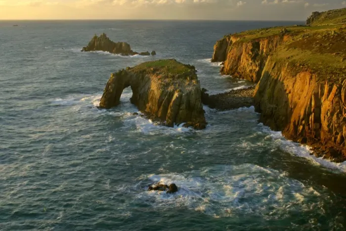 Framed Print : Lands End rugged coastline with rock arch in last evening light Lands End, Cornwall, England, UK Framed Print : Lands End rugged coastline with rock arch in last evening light Lands End, Cornwall, England, UK