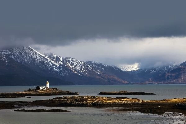 Lighthouse on the Isleornsay catching a moments sunshine in atmospheric conditions - Isle of Skye - Scotland