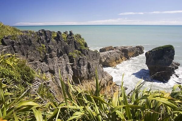 Limestone outcrops on cliffs and offshore Punakaiki South Island New Zealand
