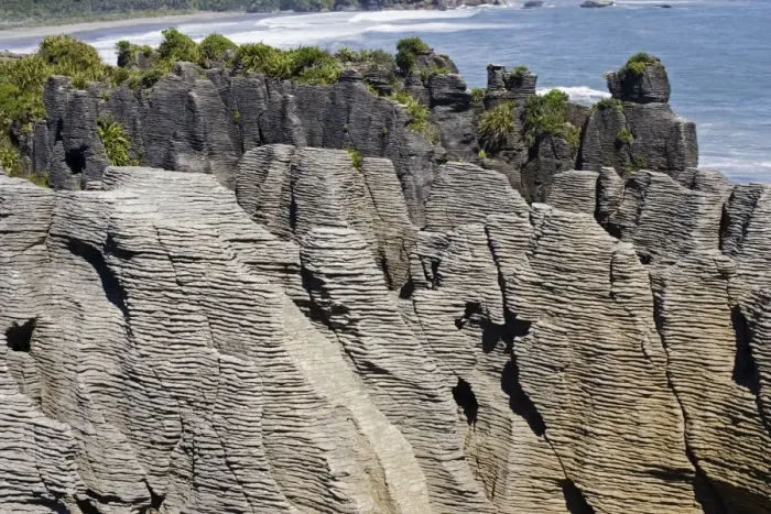 Framed Print : Limestone outcrops on cliffs. Punakaiki South Island - New Zealand. Pancake rocks form the main focus for visitors in Paparoa National Park where high outcrops of limestone have been formed by a process called stylobedding Framed Print : Limestone outcrops on cliffs. Punakaiki South Island - New Zealand. Pancake rocks form the main focus for visitors in Paparoa National Park where high outcrops of limestone have been formed by a process called stylobedding