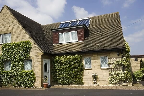 MAB-402. Modern solar panels on roof of detached house. Cotswolds UK. Mark Boulton