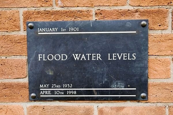 MAB-429. UK - Brass plate displaying high flood levels on wall of house