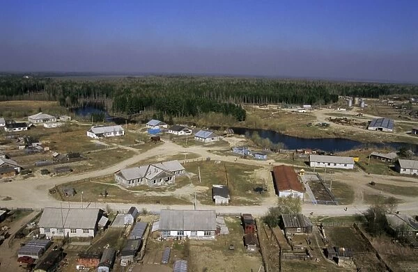 Maloyuganskii village, aerial view over the village and taiga-forest, a fog visible over horizon due to uncontrolled forest fires; a typical siberian village on a small river - a tributary of river Bolshoi Ugan, near Surgut, Siberia