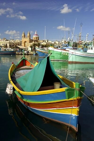 Malta - Marsaxlokk Bay is charming, and the most important fishing port on. The multi-coloured fishing boats are traditional Maltese and are called 'Luzzu' The Bay is vulnerable
