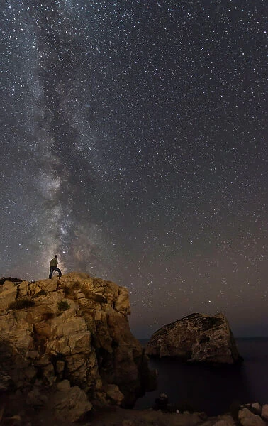 Milky Way with man standing on the edge