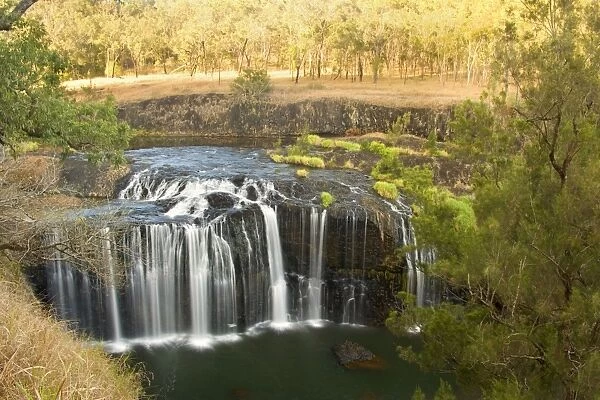 Millstream Falls - water cascades down a basalt cliff into a beautiful pool. Millstream Falls is Queensland's widest waterfall - Millstream Falls National Park, Atherton Tablelands, Queensland, Australia