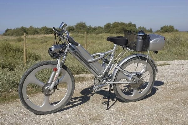 Modern electric bicycle with strong but lightweight frame, solid wheels, disk brakes, and special luggage carriers, France