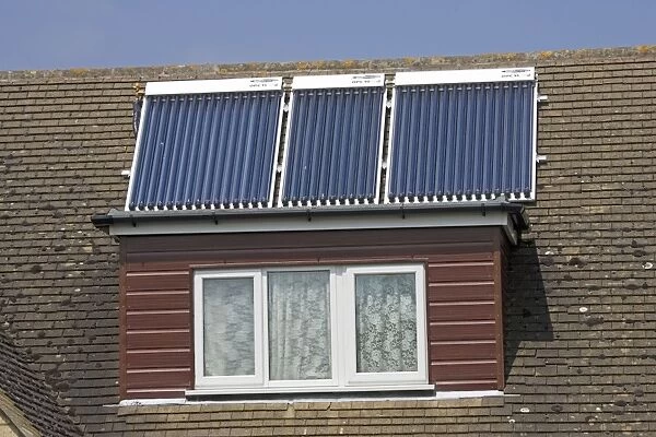 Modern solar panels on roof of detached house Cotswolds UK