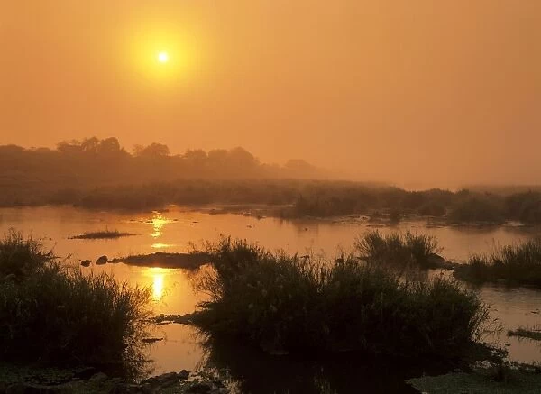 Morning mist sunrise over Sabie river with morning mist and reflection Kruger National Park, South Africa