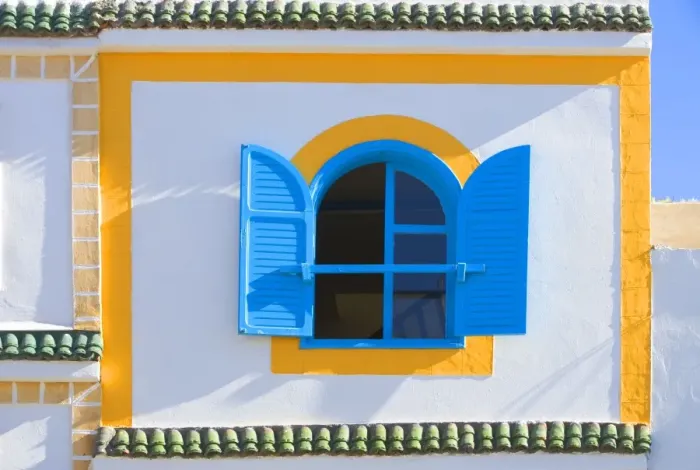 Framed Print : Morocco - brightly coloured house wall & window Framed Print : Morocco - brightly coloured house wall & window
