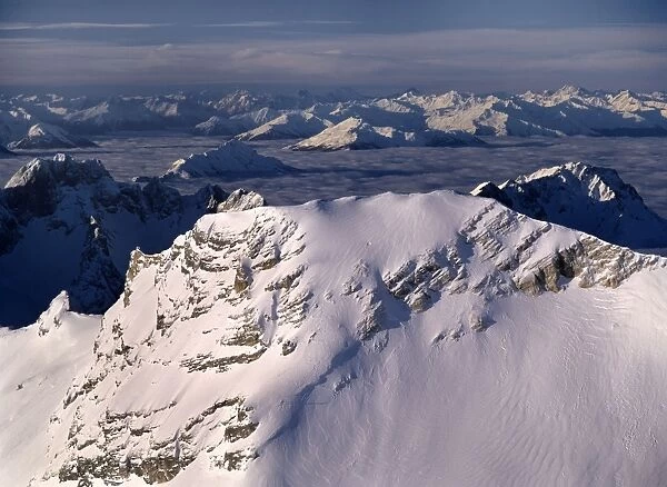 Mountain peaks view from the mountain of Zugspitze over numerous mountain summits during an inversional weather situation with the summits sticking out of the fog Bavaria, Germany