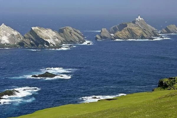 Muckle Flugga lighthouse most northerly lighthouse of Great Britain and Gannetries situated on offshore cliffs seen from Hermaness Nature Reserve Unst, Shetland Isles, Scotland, UK
