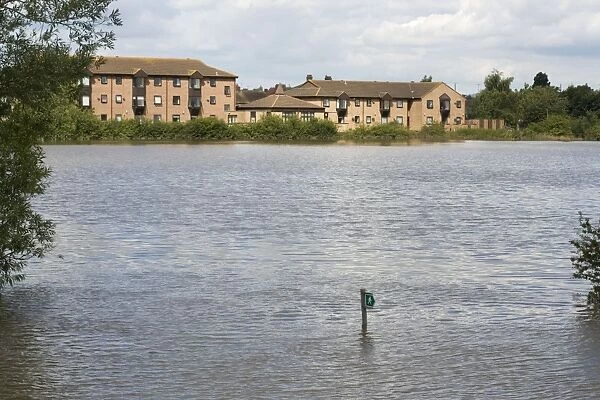 New houses built on flood plain with submerged footpath sign Newtown - Tewkesbury - Gloucestershire - UK following unprecedented flooding of Rivers Severn and Avon July 2007