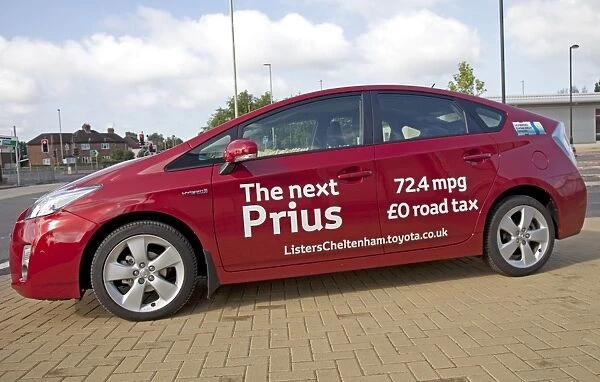 New Prius T3 hybrid red motor car fuel consumption - August 2009 parked outside Homebase in Cheltenham - Currently the world's most advanced hybrid car capable of more than 75 mpg