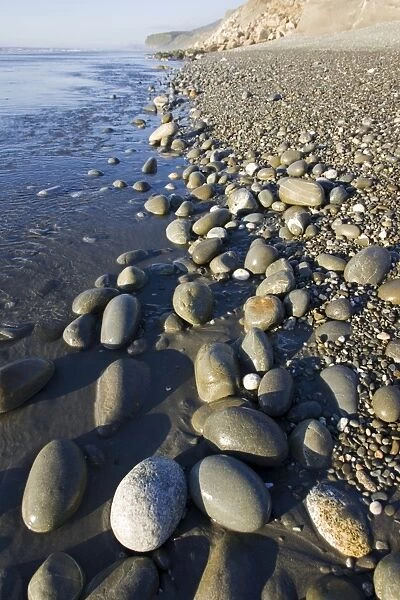 New Zealand - deserted pebble beach at low tide near Punakaiki - South Island
