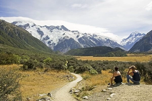 New Zealand - two hikers take a rest to enjoy scenery