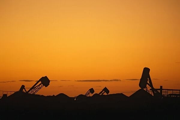 Opal mining silhouette of mining operation with blower, sunset Coober Pedy, South Australia JLR05475