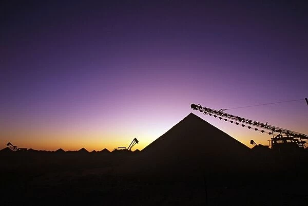 Opal mining silhouette of mining operation with self tipper shaft, sunset Coober Pedy, South Australia JLR05480