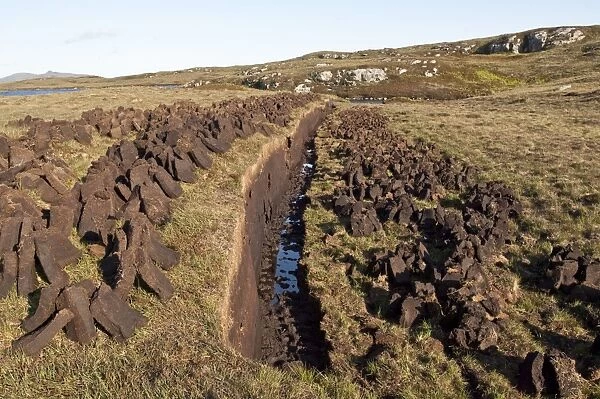 Peat cutting - with cut peat left to dry for domestic fires - North Uist - Outer Hebrides - Scotland