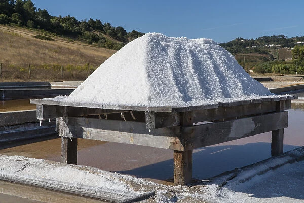 Pile of salt drying on wooden decks at Rio Maior