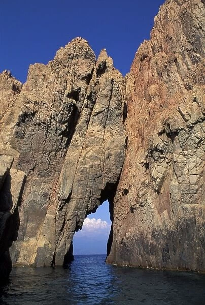 Pink Granite rock formation and tunnel over the sea - Corsica