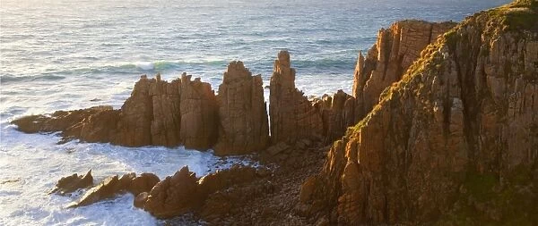 The Pinnacles - famous rock formation protruding into the ocean, late evening light. Phillip Island, Victoria, Australia