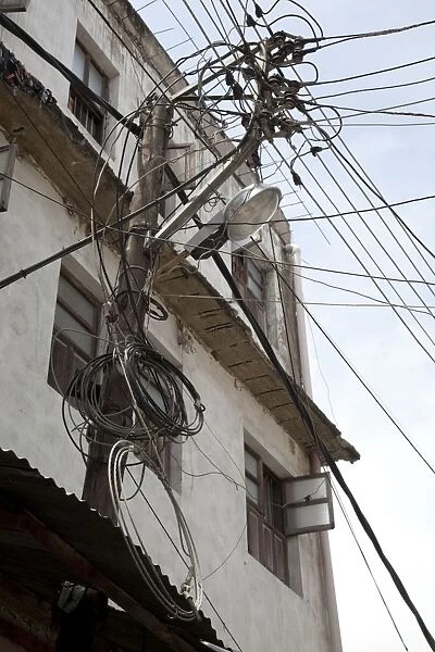 Pole with mass tangled mains electricity cables - Old Town Mombasa - Kenya