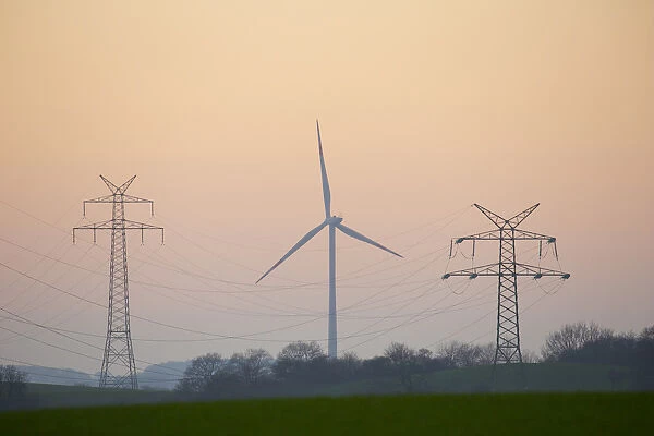 Power pole and wind turbine in sunset - Germany