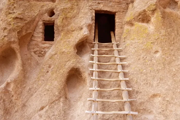 Framed Print : Pueblo Ruins - cave dwelling in Frijoles Canyon - wooden ladders lead into the cave by hand carved openings - these ruins were occupied for nearly 500 years until the late 1500s - Bandelier National Monument - Jemenez Mountains - New Mexico - USA