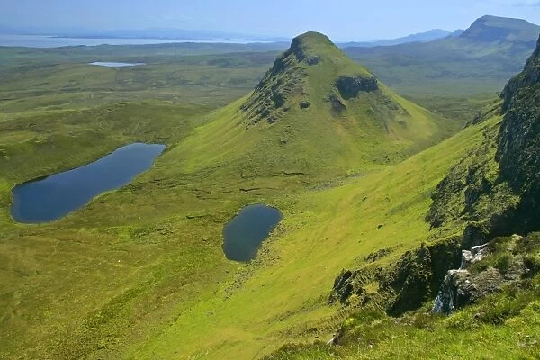 The Quiraing landscape lakes and rolling velvet green slopes sprinkled with basaltic spikes of rock and cliffs Isle of Skye, Western Highlands, Scotland, UK