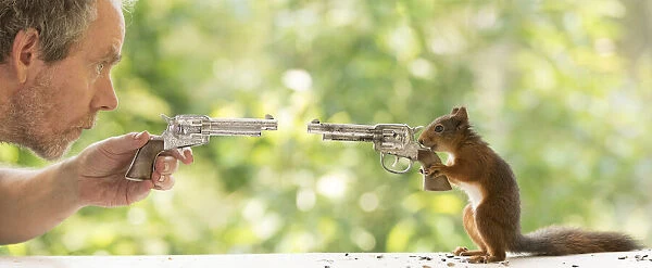 Red Squirrel and man with a gun