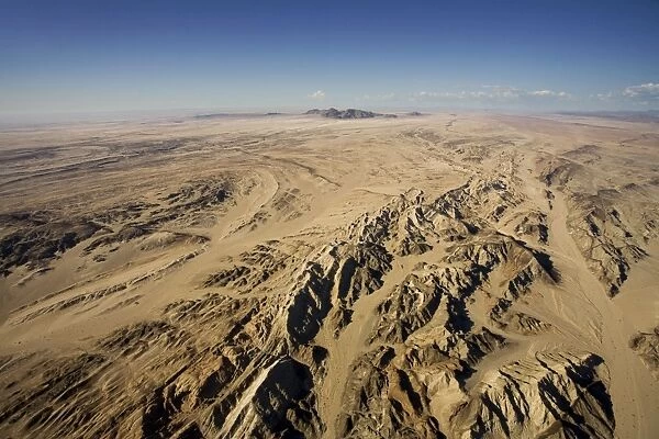 Rossing Mountain and the ancient Moon Valley landscape seen from the air - Natural drainages cut through the ancient rock below - Namib Desert - Namibia - Africa