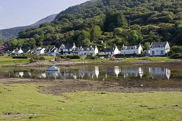 Row of cottages reflected in harbour Lochranza Isle of Arran Bute Scotland UK