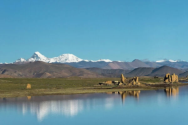 Ruins by a lake on Tibetan Plateau, Dhaulagiri (8167m) in the distance on the left, Shigatse Prefecture, Tibet, China Date: 12-09-2018