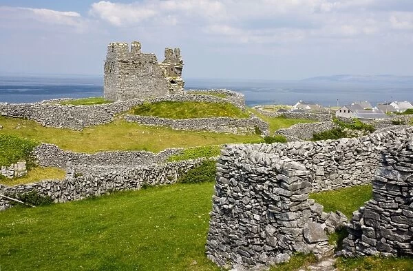 Ruins of the medieval O'Brien castle among small stone-walled fields, on Inisheer the Burren, western Eire